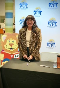 Smiling guest speaker at library event