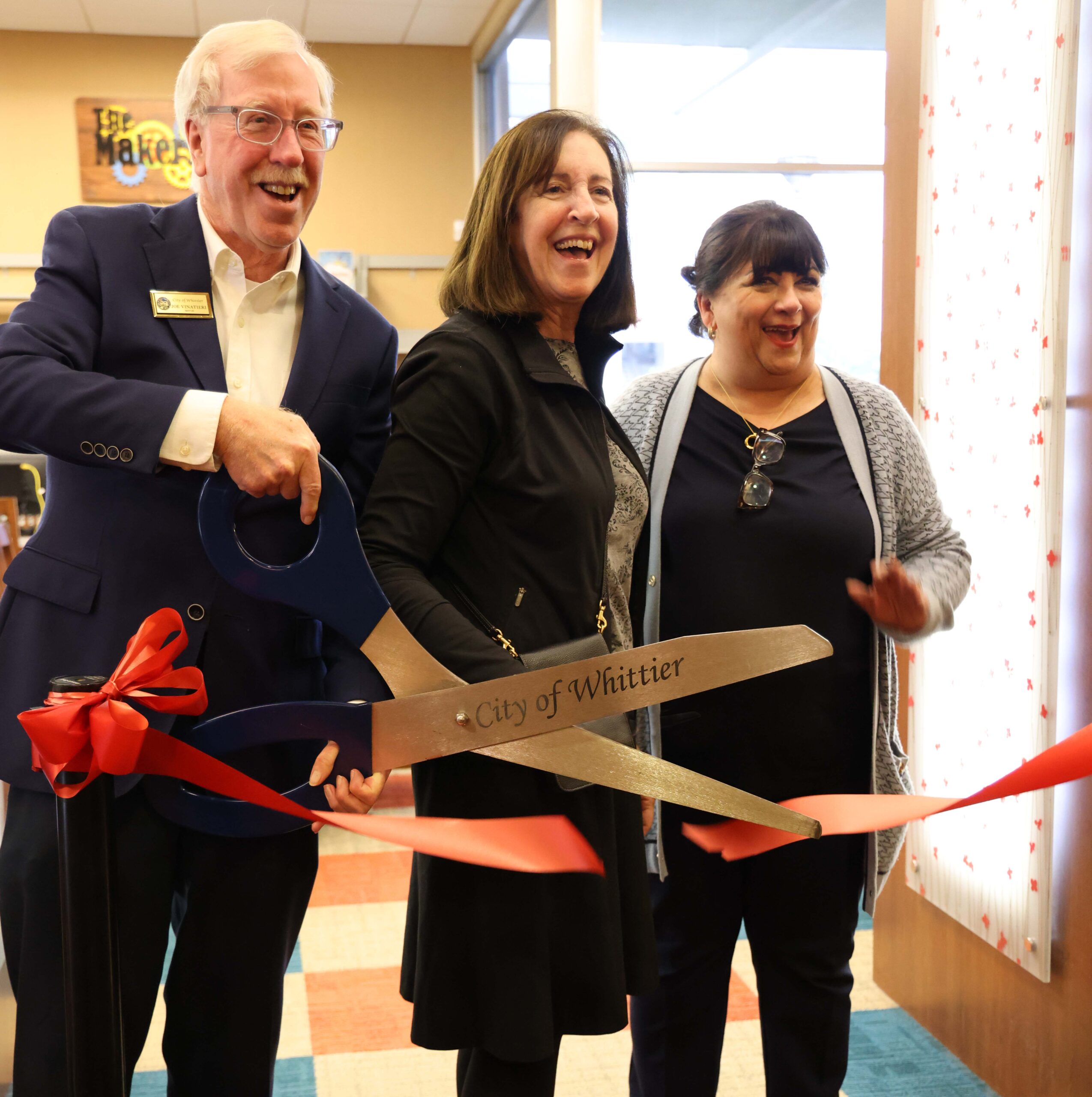Three Members Cutting Ribbon Three Members Cutting Ribbon