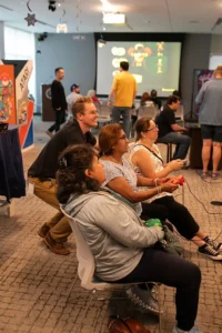 Visitors seated with game controllers