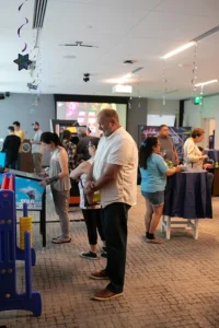 People playing arcade games at library event
